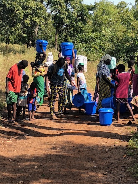 Community members in Ghana distributing water