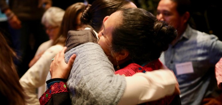 members of indigenous funders hugging